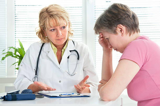 Mid adult woman talking to doctor about her diagnosis