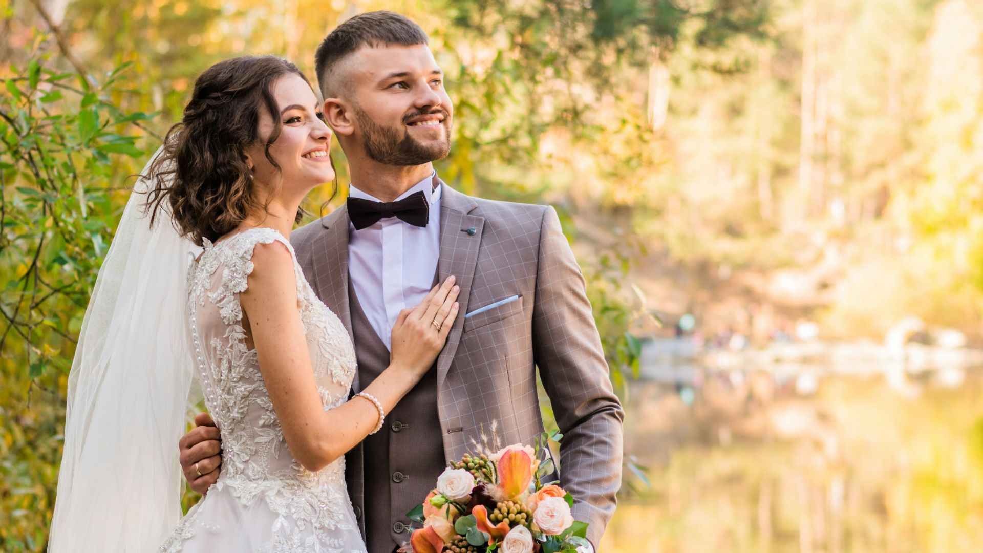 man in gray suit and woman in white wedding dress